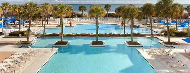 View of the Large Outdoor Pool at the Marriott Resort Grand Dunes in Myrtle Beach lined with Palm Trees 650