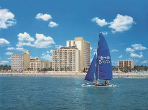 View of a Sailboat on the Ocean at Myrtle Beach looking at the Water Park Resorts on the Shore 1000