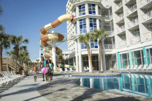 Family having fun at the water park with lazy river and water slides at the Ocean at the Crown Reef Beach Resort Myrtle Beach 1200